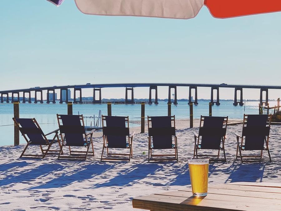 Beach chairs facing the Navarre Beach Bridge