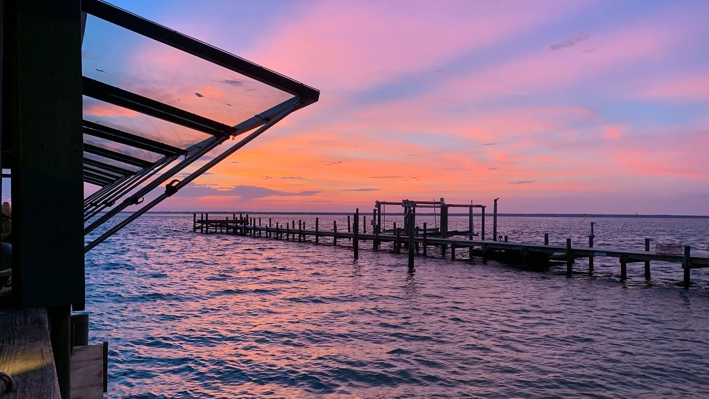 Sunset over the dock at Dewey Destin's
